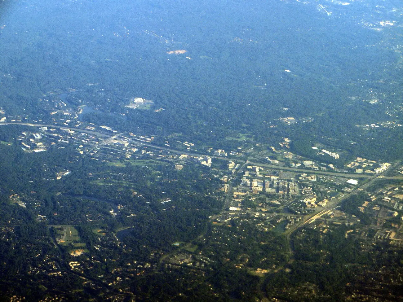 Reston from the air, with the Dulles Toll Road and the Silver Line running through the wooded neighborhoods