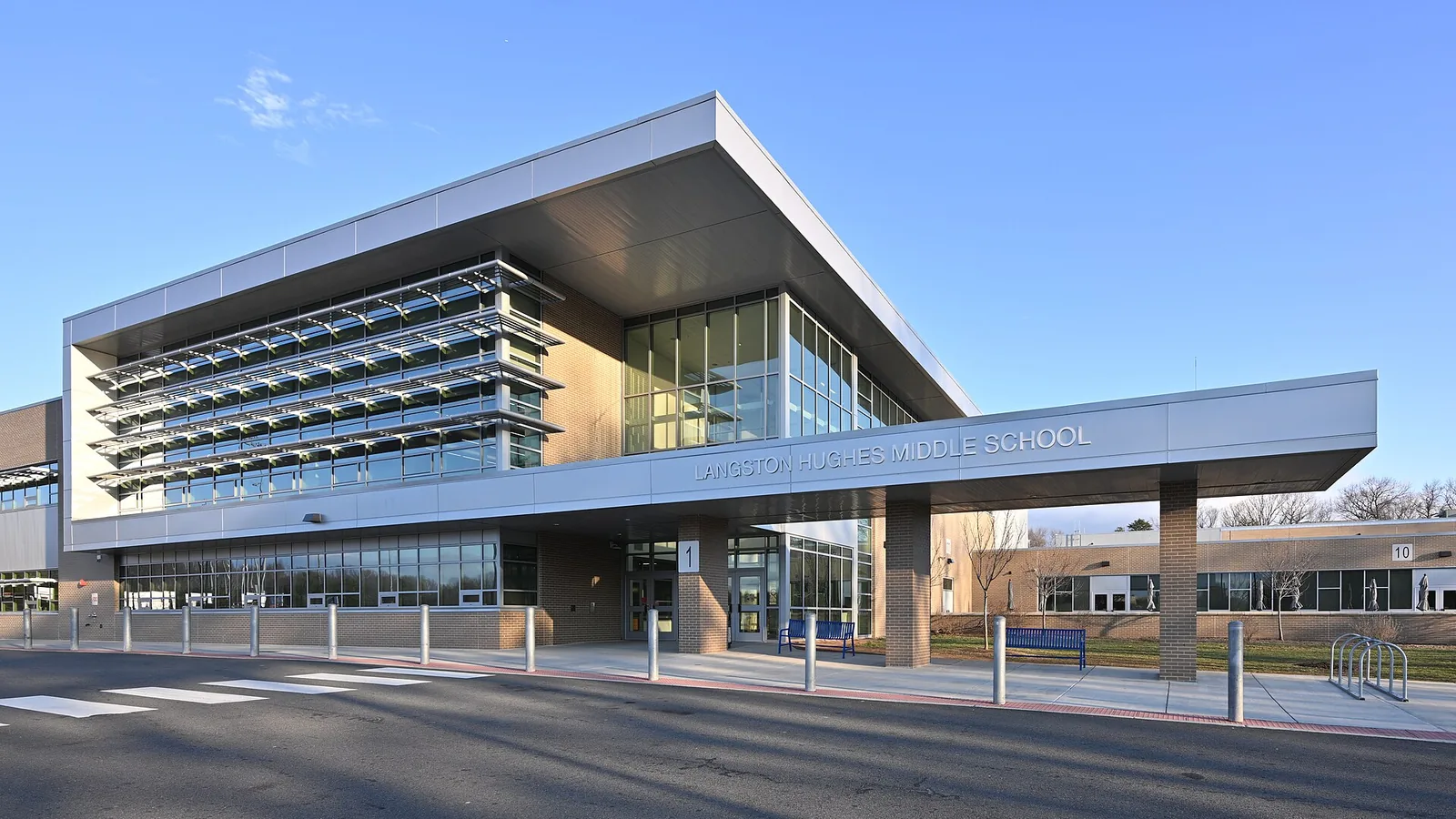 The two-story front addition and main entrance of Langston Hughes Middle School on Ridge Heights Road in Reston